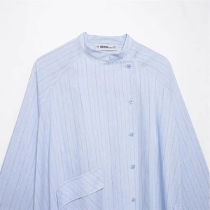 Women's light blue vertical striped shirt with asymmetrical button closure and stand collar
