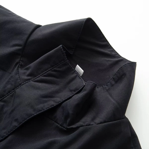 Detail shot of the stand collar and stitching on this black casual women's jacket