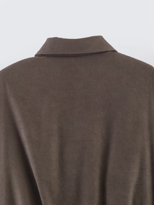 Detail view of the polo collar and shoulder stitching on a dark brown casual jacket