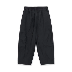 Detail of adjustable drawstring waist and functional fabric on black cargo pants