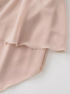 Close-up of light pink chiffon fabric with delicate rolled hem and flowing layers