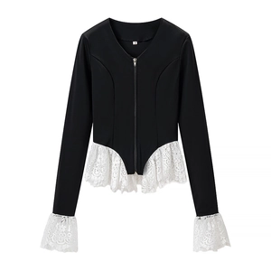 Close-up of black V-neck top with white floral lace trim and front zipper detail