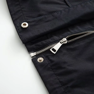 Close-up of high-density fabric jacket with silver metal zipper and button details