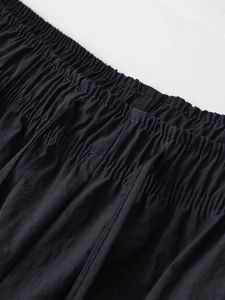 Detailed shot of an elastic waistband with adjustable drawstrings on black joggers pants