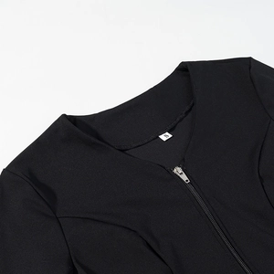 Detail of black top featuring a silver metal zipper neckline and size S label