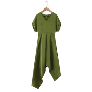 Detail of olive green V-neck dress featuring puff sleeves and asymmetric satin hemline