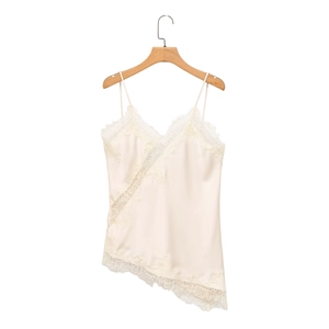 Detail of ivory satin camisole featuring delicate lace trim and asymmetric hem design