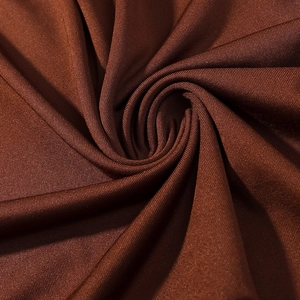 Macro shot of dark brown high-elasticity knit fabric with silky sheen and fine mesh texture