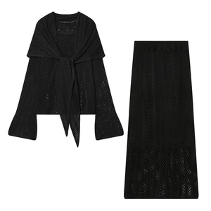 Detail of black knit two-piece set featuring intricate hollow-out wave crochet patterns