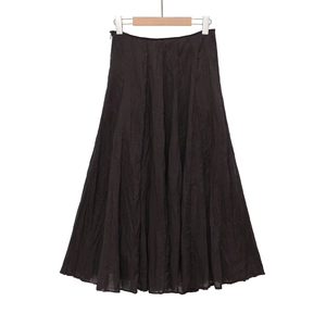 Detail view of black A-line midi skirt showing the lightweight crinkled fabric texture