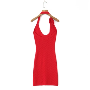 Detail of red halter knit dress featuring diamond texture and bow tie strap on hanger