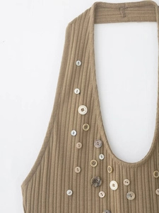 Detail of brown ribbed halter top showing various decorative buttons on the neckline