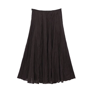 Detail shot of the black pleated midi skirt fabric with subtle vertical texture and folds