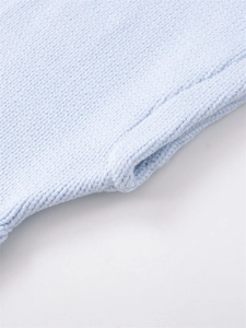 Macro shot of light blue knit fabric showing soft texture and detailed stitching