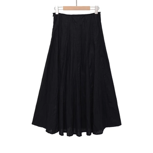 Detail view of the black midi skirt featuring textured crinkle fabric and flared silhouette