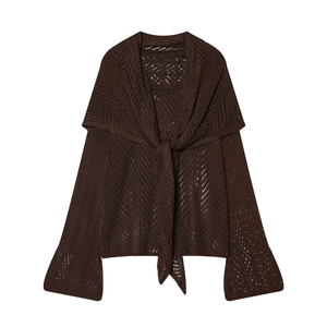 Detailed macro view of chocolate brown crochet knit sweater and shawl with flare sleeves
