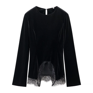 Detailed close-up of velvet texture and intricate lace hem on this black long-sleeve top