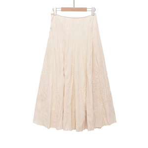 Detail of off-white midi skirt with natural crinkle texture and cotton linen fabric
