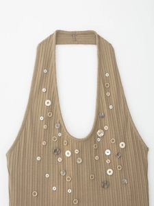Close-up of khaki ribbed knit halter top with decorative buttons and deep V-neck detail