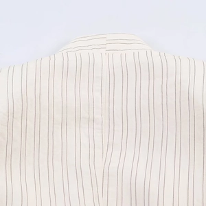 Minimalist beige striped blazer featuring a detailed view of the shoulder and collar stitching
