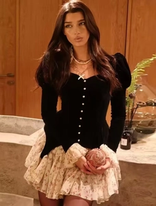 Detail of velvet top with pearl buttons and floral tiered skirt on the model