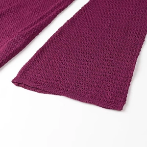 Close-up of the hollow knit texture and flared cuff detail on a purple knit dress