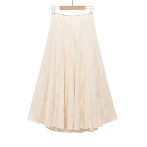 Detail of off-white midi skirt showing natural wrinkled texture and A-line silhouette