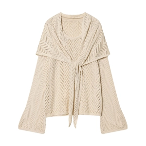 Detail of knit three-piece set showing hollow-out texture and tie-up design in beige