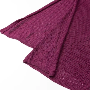 Close-up of the breathable purple crochet knit texture and detailed hem of the V-neck dress