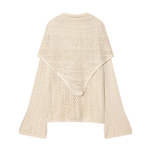 Detailed close-up of cream white hollow out knit top with geometric crochet patterns