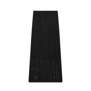 Detailed view of black knitted maxi skirt with herringbone hollow-out pattern and elastic waist