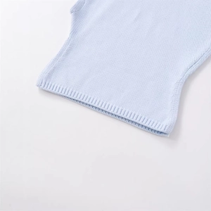 Light blue knit sweater showing loose hem and detailed ribbed knit texture on white background