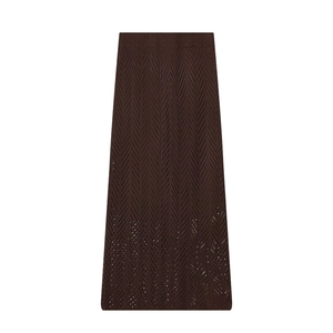Detail of dark brown knit maxi skirt featuring a hollow herringbone crochet texture