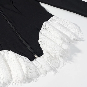 Women's black knit top featuring a metal zipper and white eyelash lace trim detail