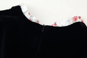 Detail of black velvet dress neck with floral ruffle trim and invisible back zipper