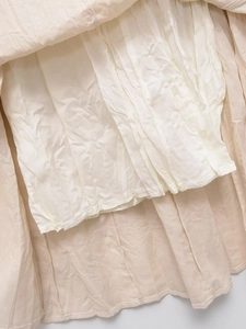 Detail of light beige midi skirt showing premium lining and neat stitching quality