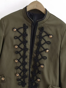 Close-up of military-style jacket featuring black frogging and vintage brass buttons