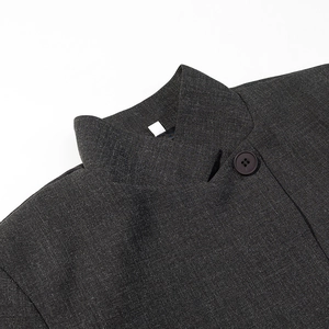 Detail of dark grey stand collar and button on wool blend blazer jacket for women