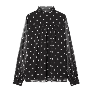 Detail of a vintage black polka dot shirt with sheer chiffon sleeves and elegant cuffs