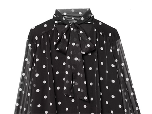 Detail of pussy-bow neckline and white polka dot pattern on black chiffon blouse