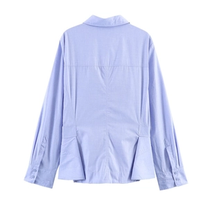 Detail view of the back of a lavender long-sleeved shirt with shirred hem and pleated back