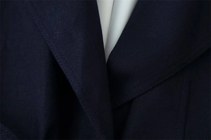 Macro di cappotto in twill blu scuro con cuciture precise sul rever della giacca