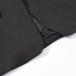 Detail of dark grey textured fabric with premium stitching and black smooth inner lining