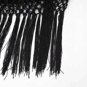Chic black velvet skirt featuring intricate handmade woven fringe and tassel details