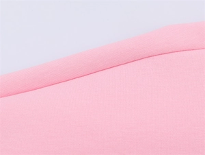 Detailed view of pink knitted fabric texture and precise stitching on the hemline
