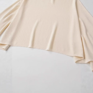 Women's off-shoulder beige knit sweater with loose sleeves and fine ribbed texture