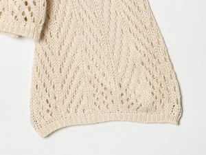 Close-up of beige crochet knit fabric with breathable hollow mesh pattern detail