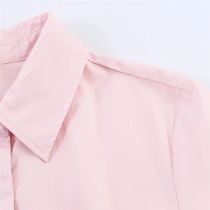 Close-up of pink button-down shirt featuring a sharp lapel collar and fine fabric texture