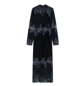 Detailed view of black velvet fabric with intricate floral lace trim on the sleeve and hem