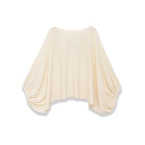 Minimalist cream off-shoulder knit top with batwing sleeves and ribbed cuffs shown on white